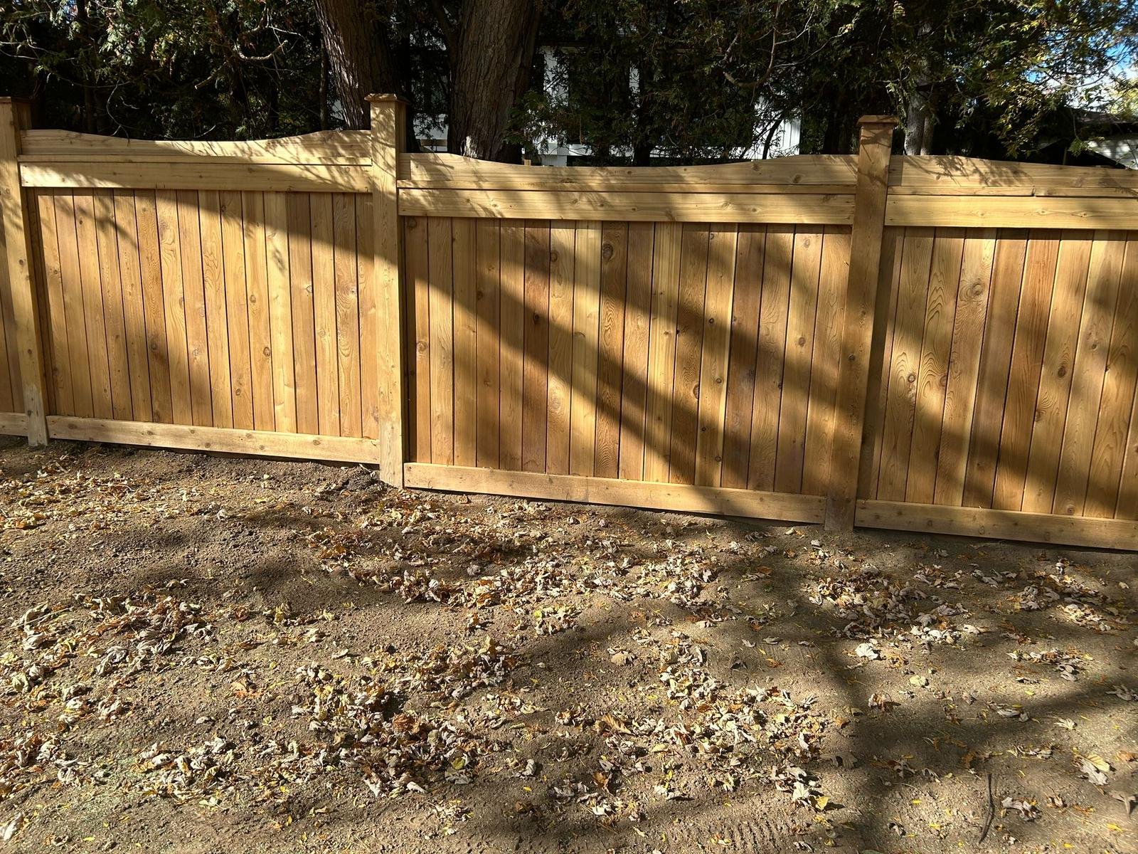 New wooden privacy fence along a backyard