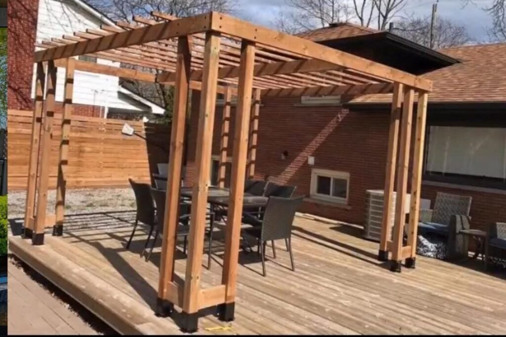 Wooden pergola on a backyard deck with patio furniture